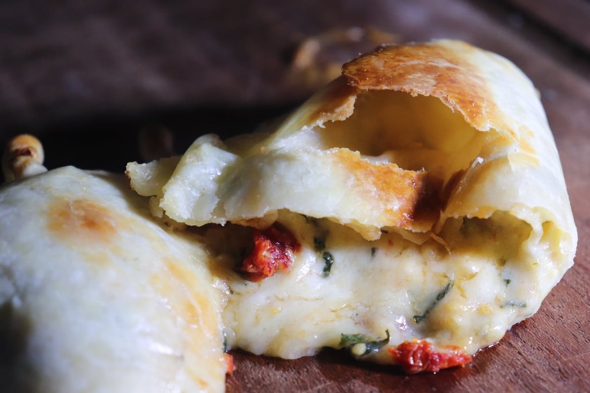 María Luisa caprese empanada with its filling visible