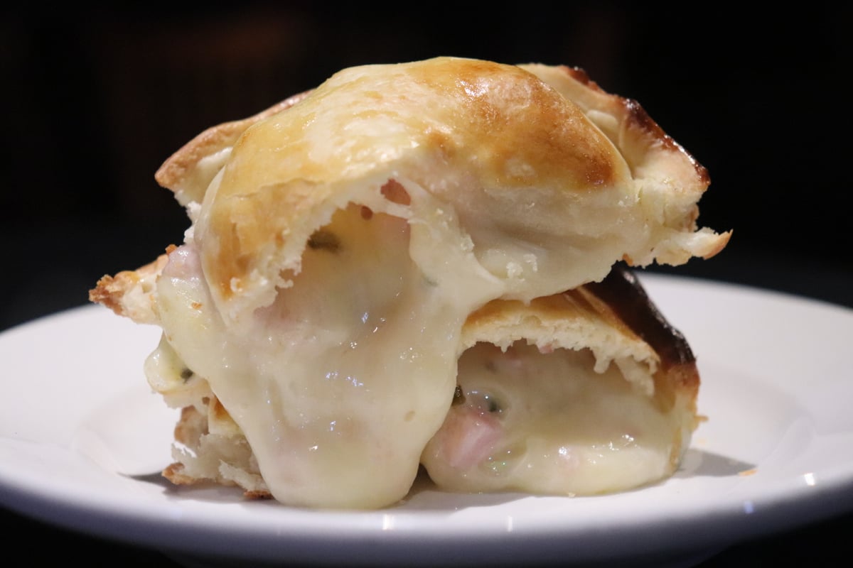 María Luisa ham & cheese empanada with its filling visible