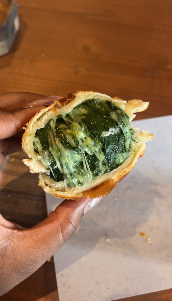 María Luisa spinach & cheese empanada with its filling visible